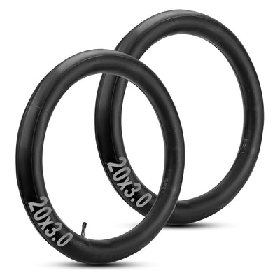 Two 20x3.0 inch black rubber bike inner tubes standing upright.