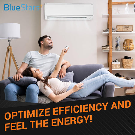 Couple relaxing on a sofa using a remote control for a wall-mounted air conditioner unit.