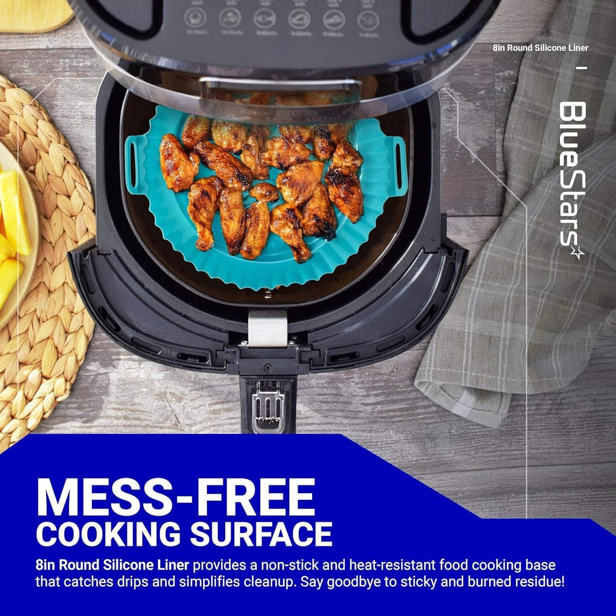 8-inch round teal silicone air fryer liner holding cooked chicken wings inside an air fryer basket.