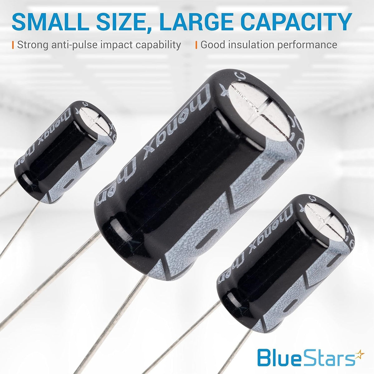 Close-up of three black aluminum electrolytic capacitors of varying sizes from the 320-piece kit.