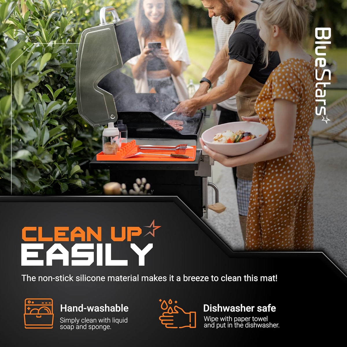 Orange silicone griddle mat holding grilling tools on a barbecue grill outdoors.