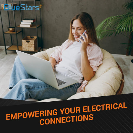 Woman sitting in a chair using a laptop and phone, representing the convenience of 20 Amp USB wall charger outlets.