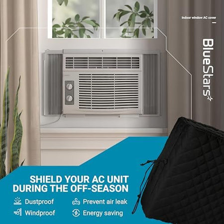 Black indoor window air conditioner cover with quilted insulation installed on an AC unit for winter protection.