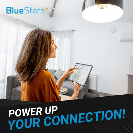 Woman using a tablet to control smart home lighting, representing the reliable connection of 2-port conductors.