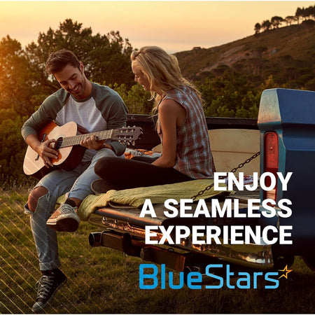Couple sitting on a Toyota truck tailgate playing guitar at sunset with BlueStars branding.