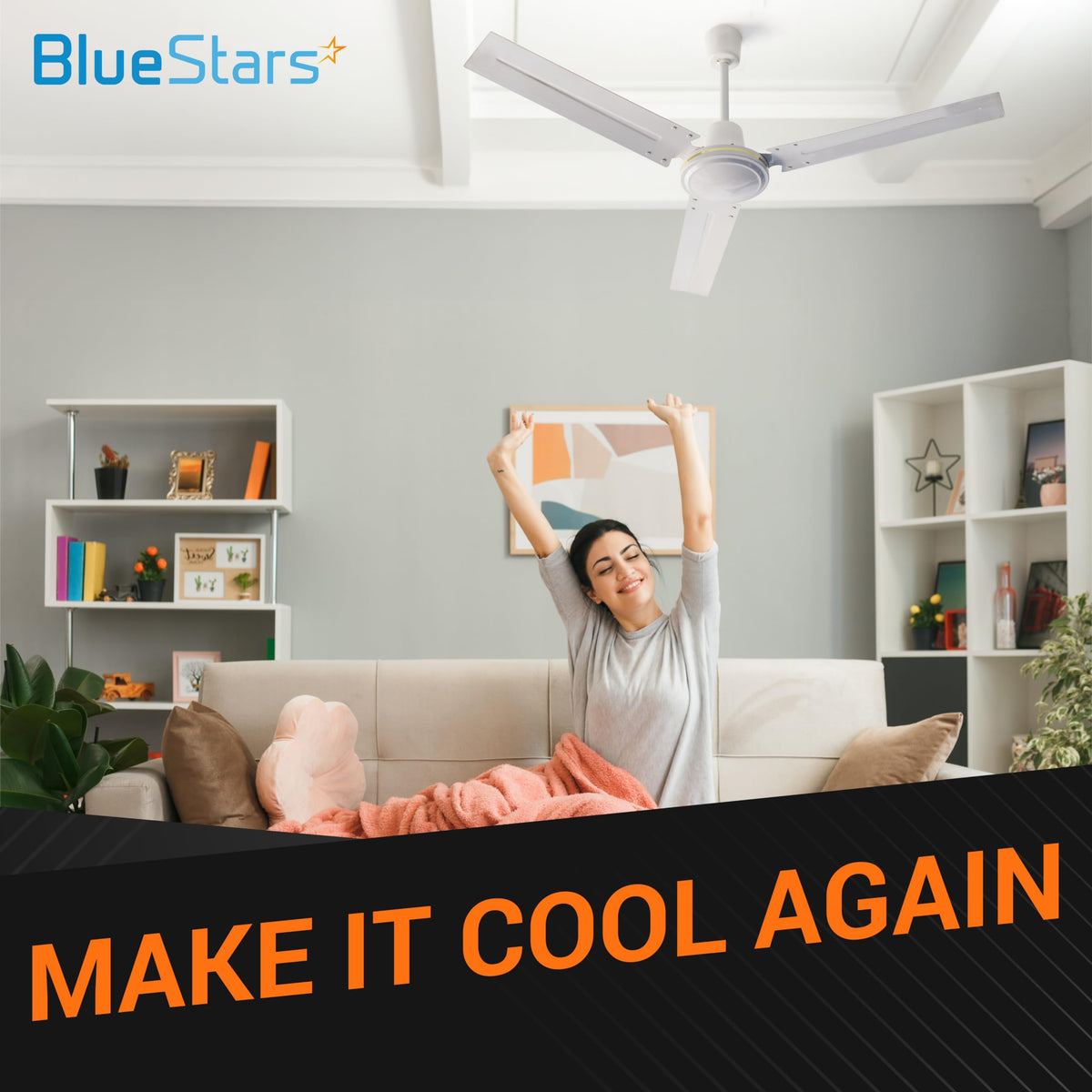 Woman relaxing under a white ceiling fan in a living room with BlueStars Make It Cool Again branding.