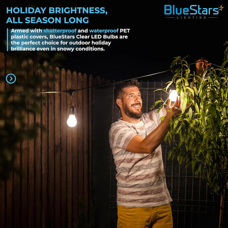 Man installing shatterproof G40 LED globe bulbs on an outdoor string light set at night.
