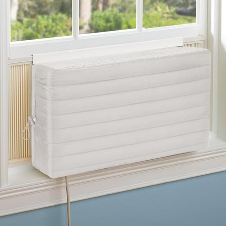 White indoor window air conditioner cover installed over a unit in a window.