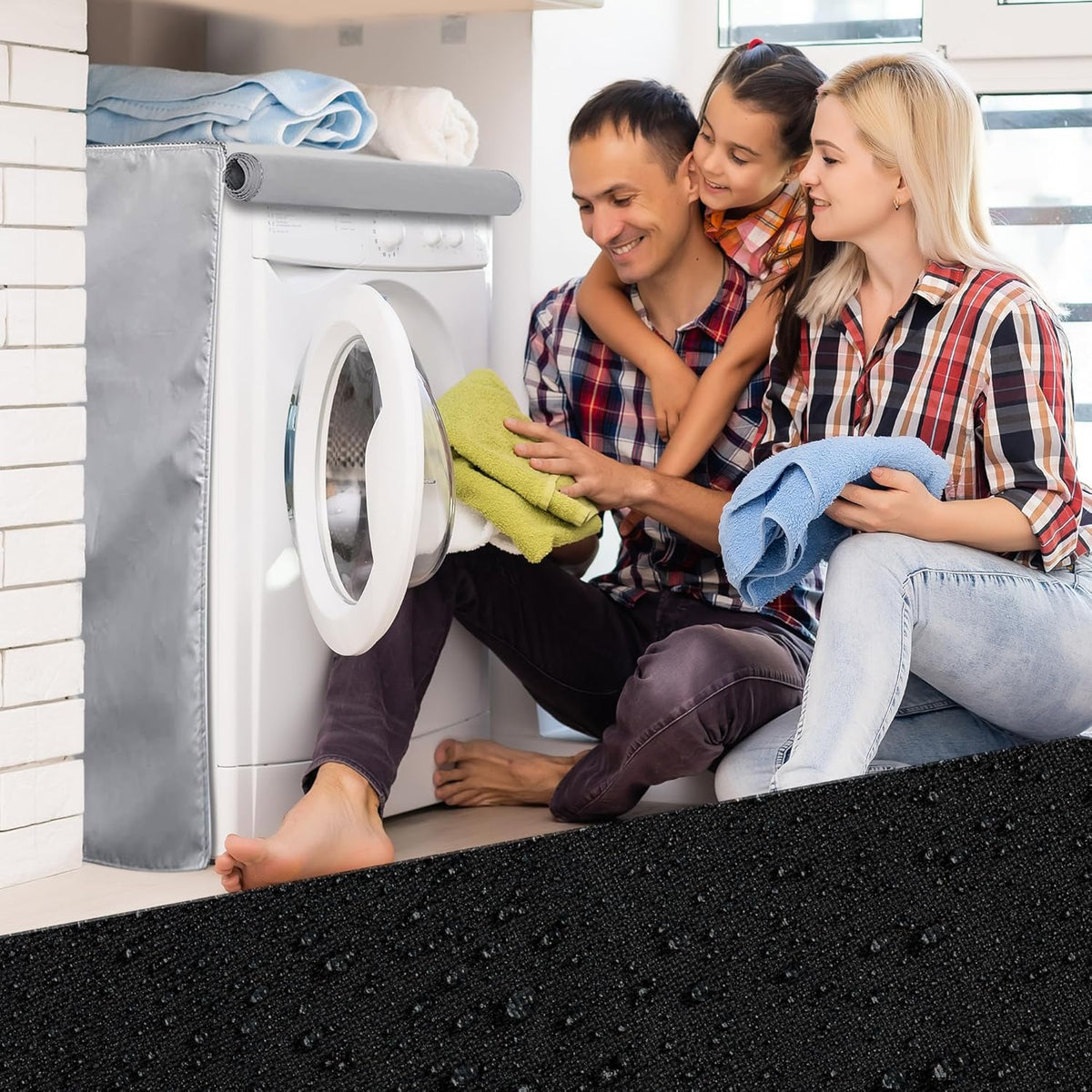 Silver premium outdoor cover installed on a front-load washing machine with a family folding laundry nearby.